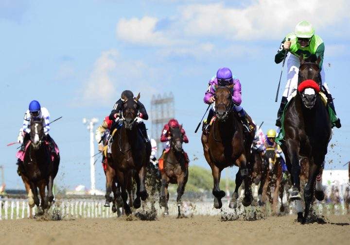 One Bad Boy, right, ridden by jockey Flavien Prat, runs the 160th Queen's Plate at Woodbine Racetrack, in Toronto on Saturday, June 29, 2019. Woodbine Entertainment is looking at a resumption of horse racing next month. 