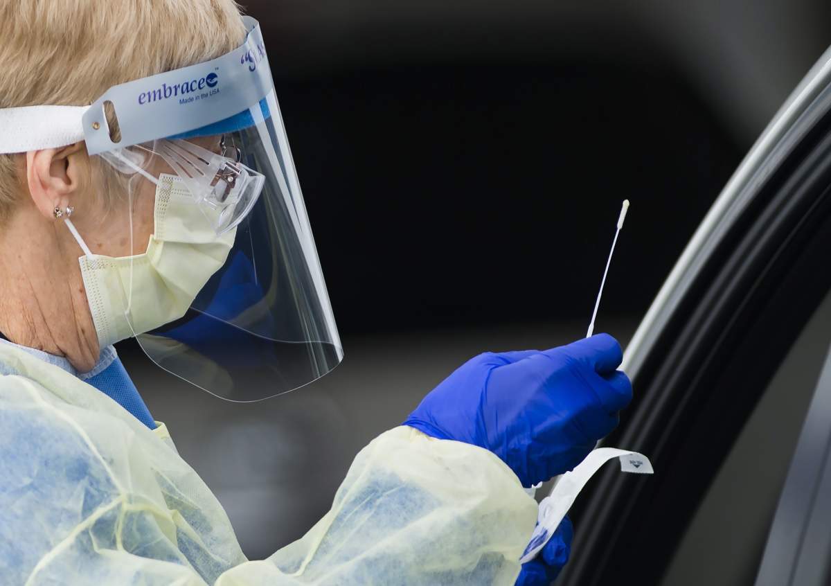 Health-care workers do testing at a drive-thru COVID-19 assessment centre at the Etobicoke General Hospital in Toronto on April 21, 2020.