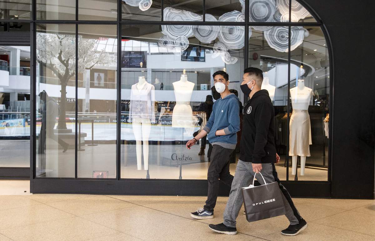 Shoppers walk past stores in West Edmonton Mall on the first day of the its reopening on Thursday, May 14, 2020, during the COVID-19 pandemic.