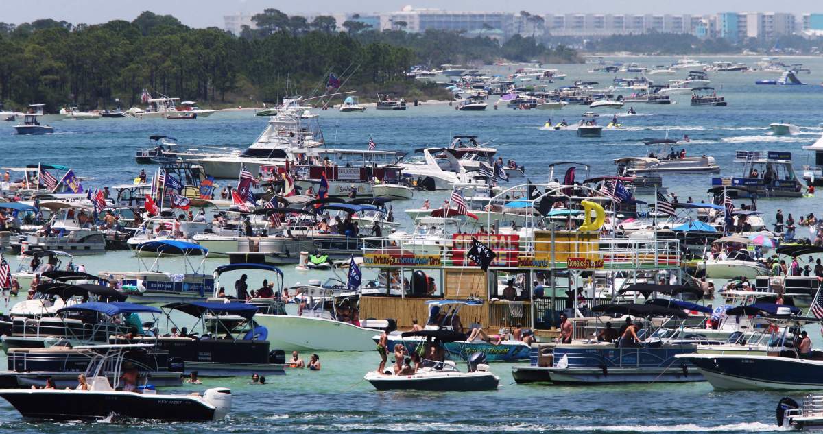 Boaters crowd an area known as “Crab Island” in the shallow waters near Destin Fla., Saturday, May 23, 2020, as the long Memorial Day weekend begins during the coronavirus pandemic.