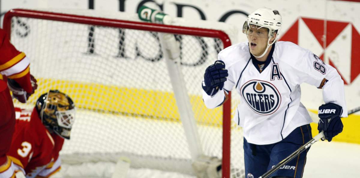 Edmonton Oilers' Alex Hemsky, right, from the Czech Republic, celebrates his goal as Calgary Flames goalie Miikka Kiprusoff, from Finland, lies in the crease during first period NHL hockey action in Calgary, Saturday, Oct. 16, 2010.THE CANADIAN PRESS/Jeff McIntosh.