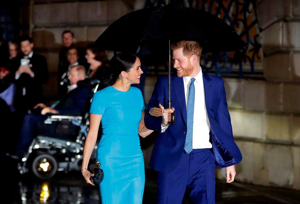 FILE - In this Thursday, March 5, 2020 file photo, Britain's Prince Harry and Meghan, the Duke and Duchess of Sussex arrive at the annual Endeavour Fund Awards in London.