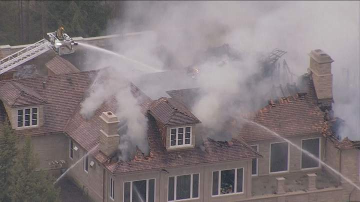 Firefighters on scene battling a fire at a home under construction in Aurora.