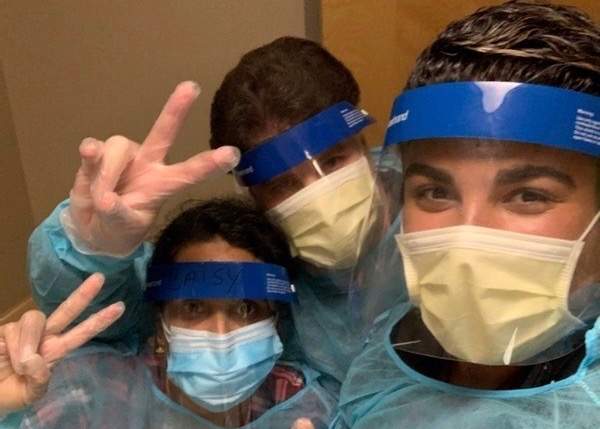 Brian Beattie (C), the first registered nurse to die of COVID-19 in Ontario, with two of his co-workers. 