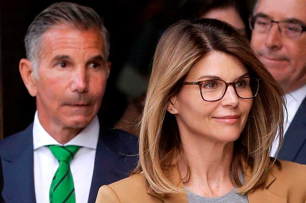 Lori Loughlin, front, and her husband, clothing designer Mossimo Giannulli, left, depart federal court in Boston after a hearing in a nationwide college admissions bribery scandal on April 3, 2019.