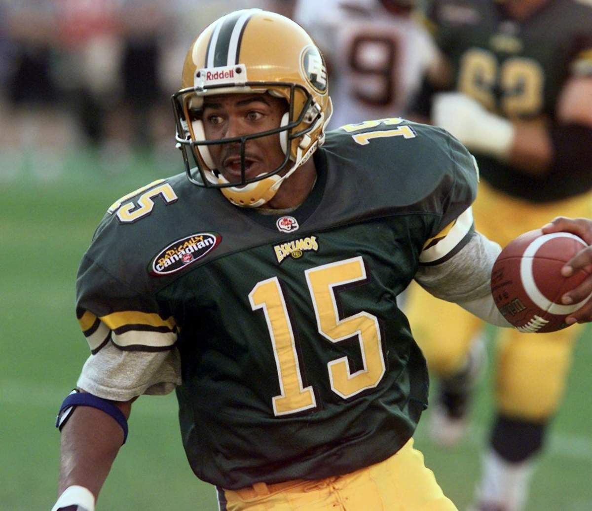 The Edmonton Eskimos QB #15 Nealon Greene scrambles in first half CFL action at Commonwealth Stadium in Edmonton Friday July 9, 1999 against the B.C. Lions.(CP PHOTO/Edmonton Journal-Ed Kaiser)   The Canadian Press Images/Edmonton Journal.