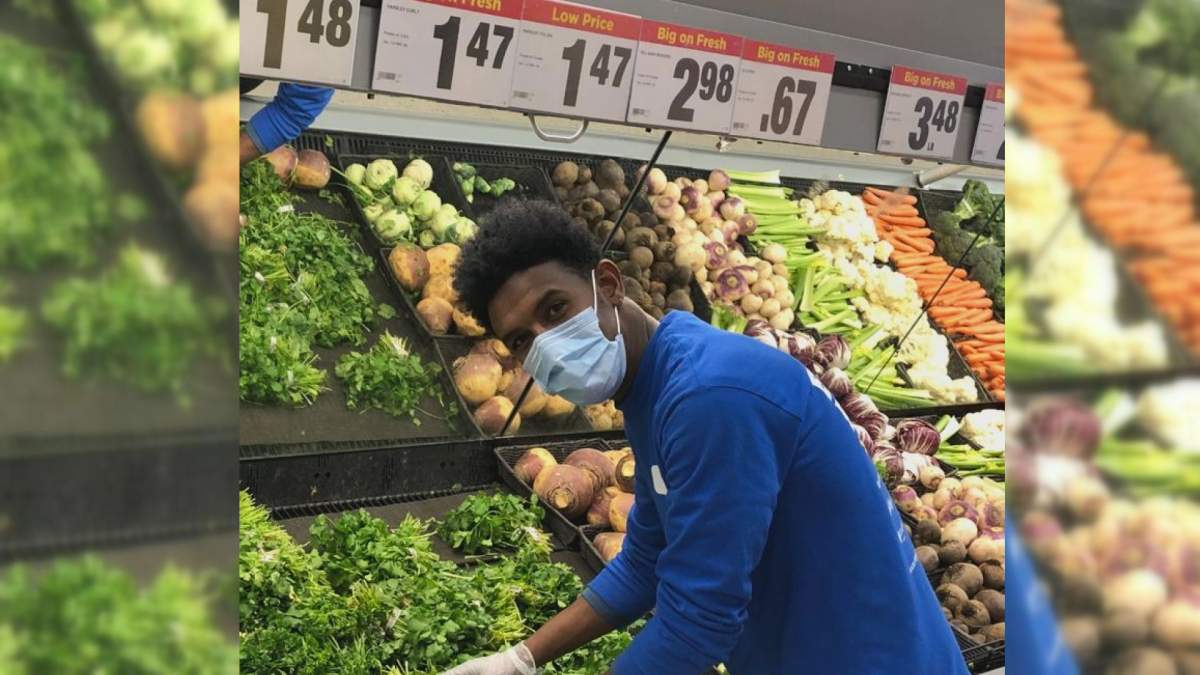 Daniel Hailemrim stocks vegetables during a shift at Golden Mile Real Canadian Superstore.