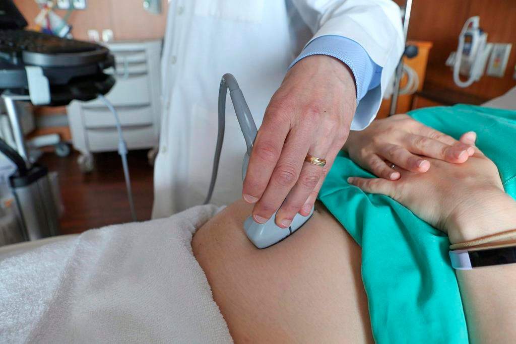 In this Aug. 7, 2018 photo, a doctor performs an ultrasound scan on a pregnant woman.