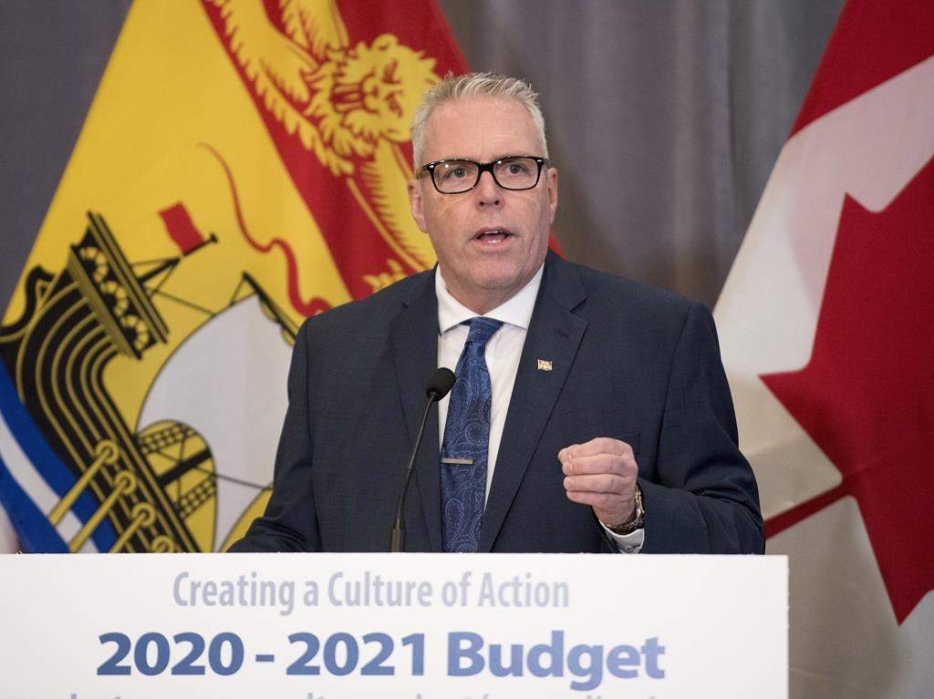 New Brunswick Finance Minister Ernie Steeves speaks at a press conference prior to delivering the provincial budget in the Legislature in Fredericton, N.B., on Tuesday March 10, 2020. The New Brunswick government is now forecasting a deficit of $299 million dollars for 2020-21, instead of the $92 million surplus it projected when it released its budget this spring.