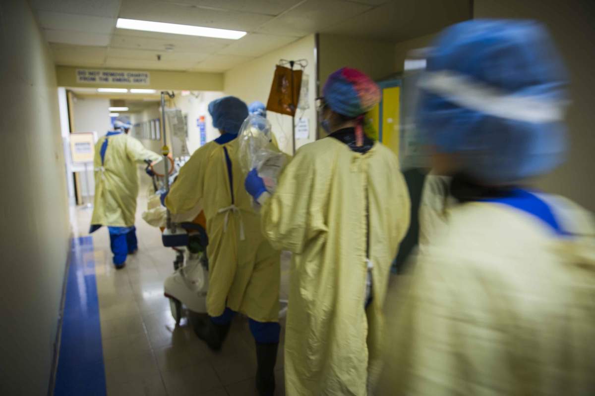 A patient with COVID-19 is rushed to the intensive care unit after being stabilized and having a breathing tube inserted.
