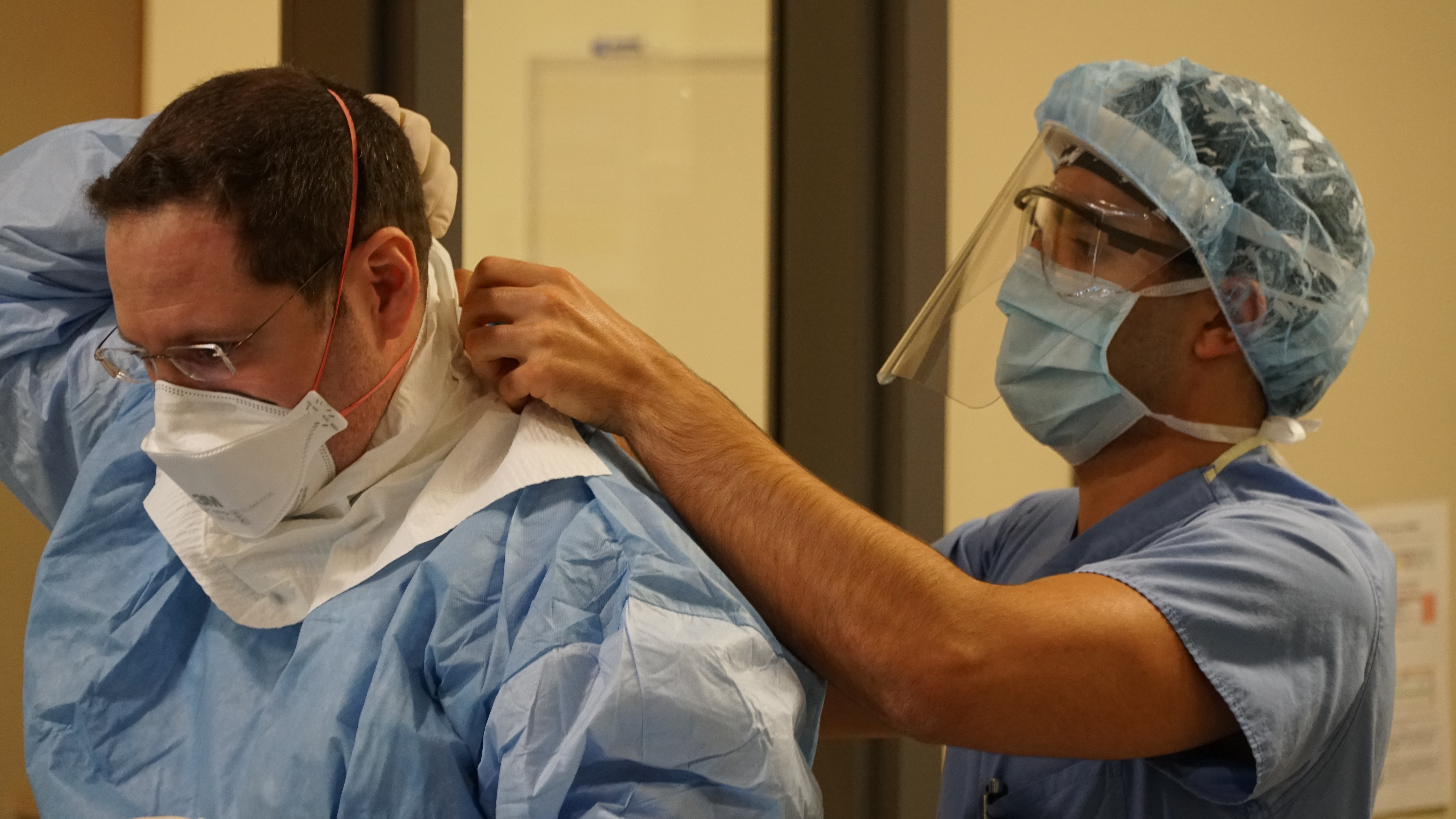 Dr. Jamie Speigelman, a critical care specialist, puts on his personal protective equipment before treating a COVID-19 patient at Toronto’s Humber River Hospital.