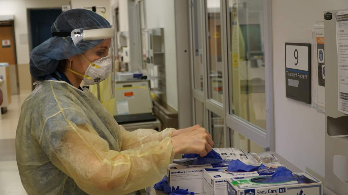 Dr. Susan Tory prepares to enter the hospital room of a patient with COVID-19.