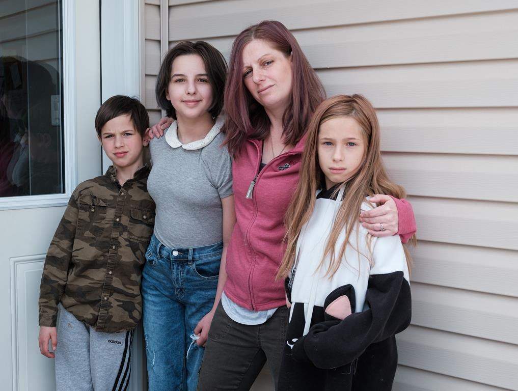 Sarah Sansom and her children, from left to right, Addison, 11, Ceirra, 13, and Daylen 8, pose for a portrait at their home in Nobleford, Alta., on Friday, May 29, 2020. Sarah’s husband, and the children’s father Jacob (Jake) Sansom and his uncle Morris Cardinal were found shot to death on a rural road in eastern Alberta in March 2020.  THE CANADIAN PRESS/David Rossiter