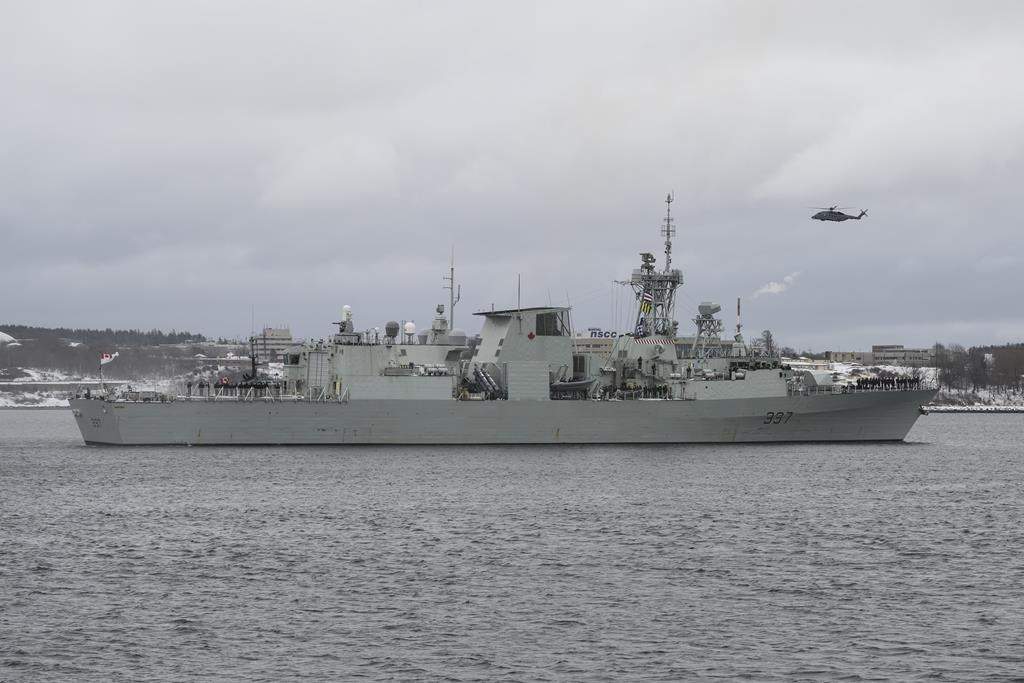 A Cyclone helicopter flies over HMCS Fredericton as its crew leaves the Halifax Harbour for a six-month deployment to the Mediterranean Sea as part of NATO’s Operation Reassurance in Halifax on Monday, Jan. 20, 2020.