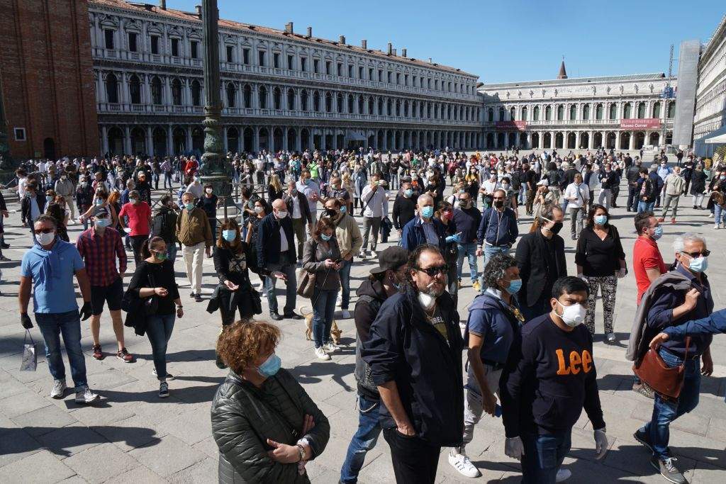 Storekeepers asking for the reopening of shops and commercial activities gather for a flashmob protest on Piazza San Marco on May 4, 2020 in Venice, as Italy starts to ease its lockdown, during the country’s lockdown aimed at curbing the spread of the COVID-19 infection, caused by the novel coronavirus.