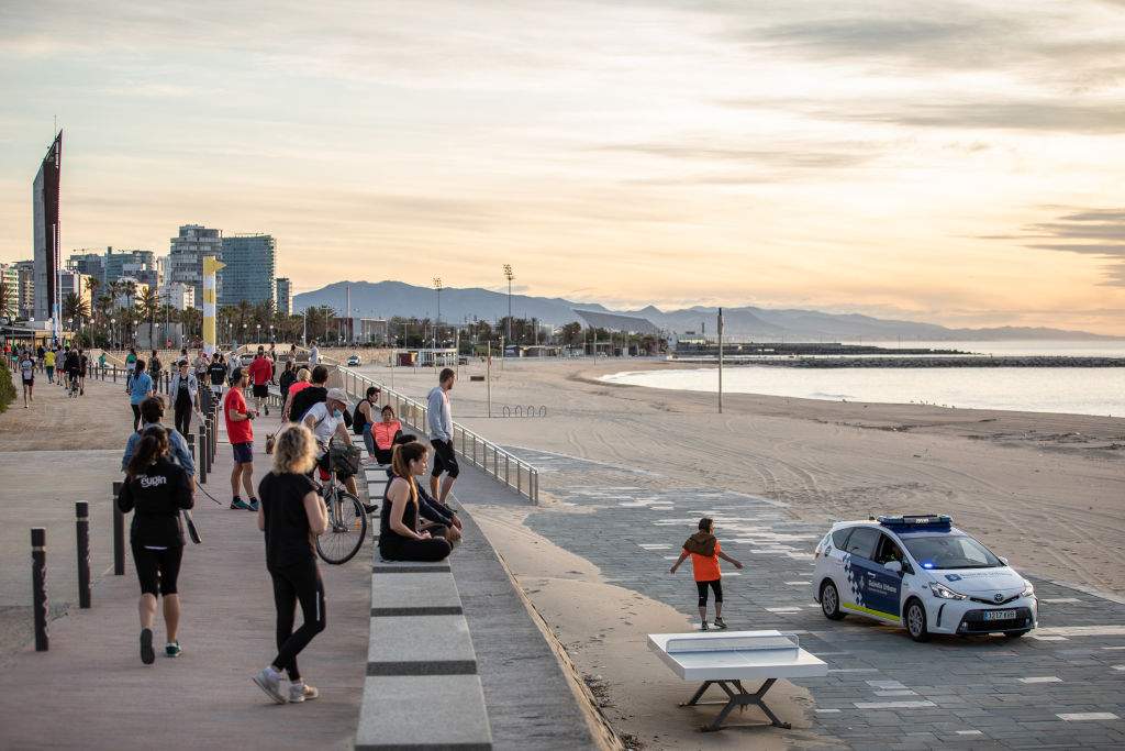 Passersby enjoy the atmosphere near the port of Barcelona on the first day the government is allowing people to go out for individual sports and walks with another person with whom they live, at certain times and up to a kilometre away from their homes, on May 2, 2020 in Barcelona, Cataluña, Spain.