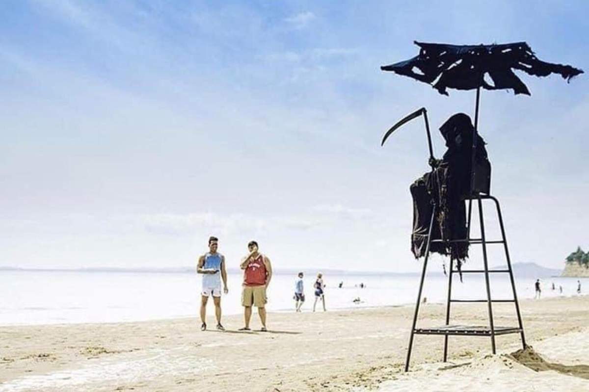 Daniel Uhlfelder is shown as the grim reaper on a beach in Florida.