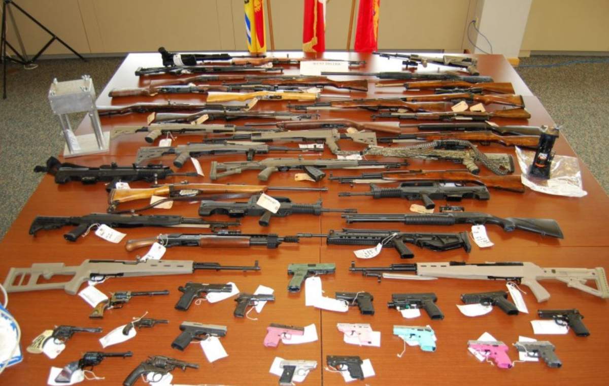 Police say they seized 31 long guns and 22 handguns, among them 24 prohibited or restricted weapons.