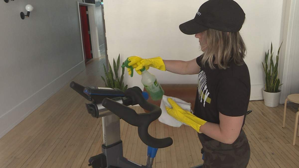 The Community Gym owner Amie Seier cleans equipment at her facility. 