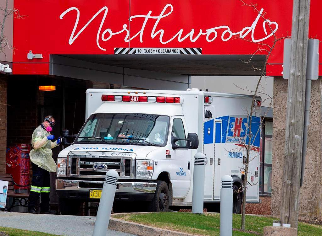A paramedic walks around an ambulance at Northwood Manor, one of the largest nursing homes in Atlantic Canada with 585 residents, in Halifax on Friday, May 1, 2020. THE CANADIAN PRESS/Andrew Vaughan