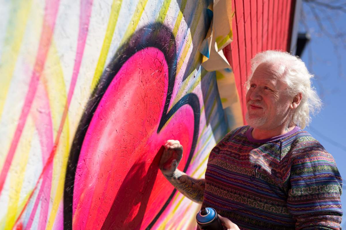 Artist Mark Harrison transforming boarded up windows into a message of hope and a reminder of the business inside.