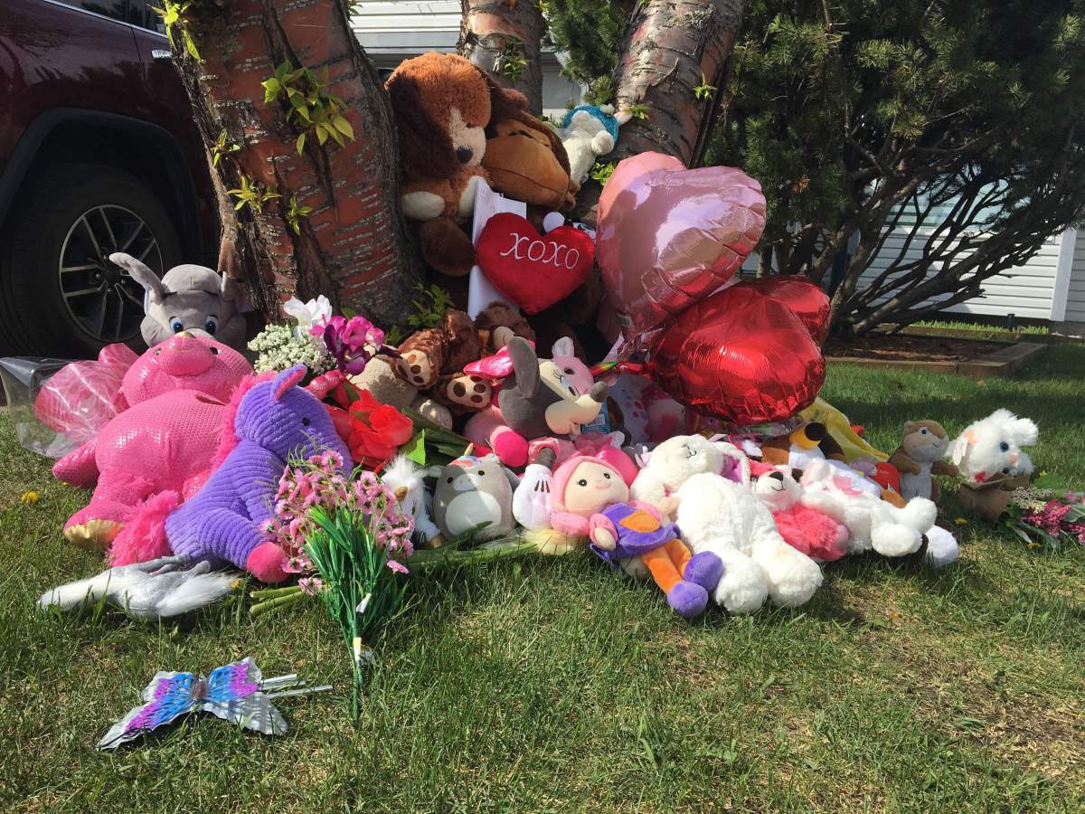 Neighbours have started a memorial for the young girl who died after a stabbing incident in Mill Woods on Monday, May 18, 2020.