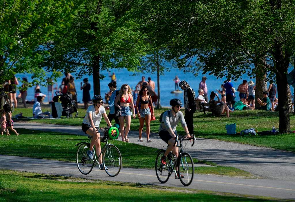 People enjoy the warm weather at Mooney's Bay Park in Ottawa, on Saturday, May 23, 2020, in the midst of the COVID-19 pandemic. THE CANADIAN PRESS/Justin Tang.
