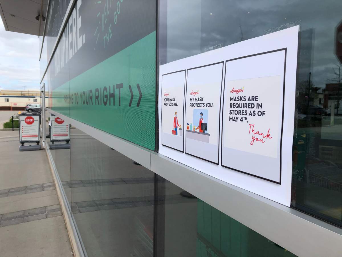 Signs requiring all customers to wear face masks or face coverings posted at a Longo’s grocery store in Toronto on May 4, 2020.