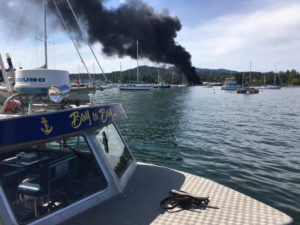 A plume of smoke is seen coming from the North Saanich Marina. One person has died and two people have been taken to hospital with non-life threatening injuries after an explosion and fire.