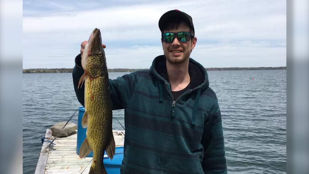 Cody Wheeler holds a Chain Pickerel he caught a week ago