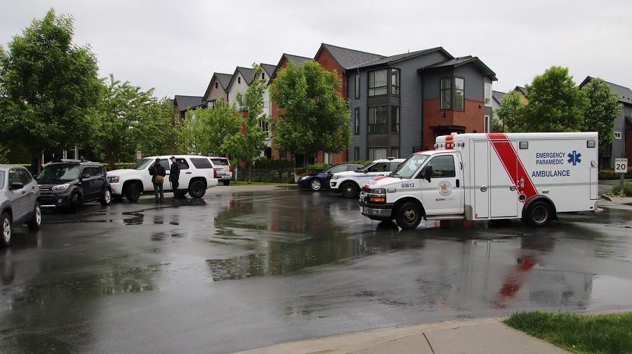 Police and paramedics attend a townhouse complex in Port Coquitlam where an infant was found abandoned on Saturday. 