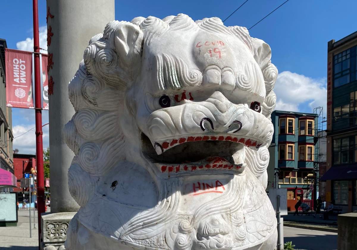 Racist graffiti seen on the lions at the base of the Millennium Gate in Vancouver's Chinatown. 