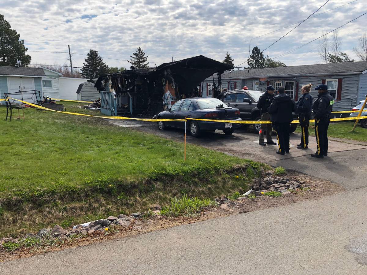 RCMP officers and Moncton fire investigators attend the scene of a fatal fire at a mobile home on Nancy Street in Moncton Saturday morning.