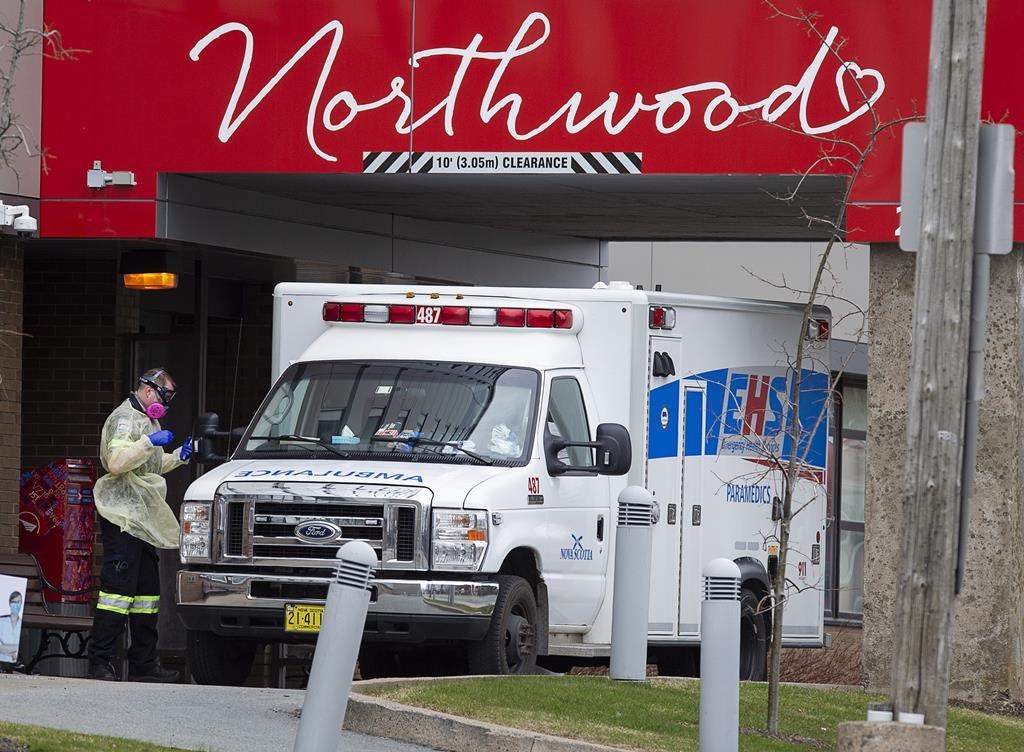 A paramedic walks around an ambulance at Northwood Manor, one of the largest nursing homes in Atlantic Canada with 585 residents, in Halifax on Friday, May 1, 2020.