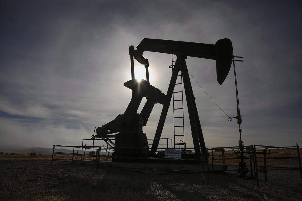 A pumpjack works at a well head on an oil and gas installation near Cremona, Alta., Saturday, Oct. 29, 2016.  THE CANADIAN PRESS/Jeff McIntosh.