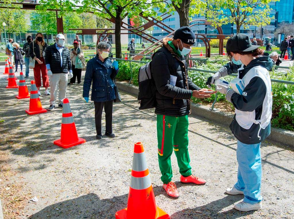 People line up at a mobile COVID-19 testing clinic, Tuesday May 19, 2020 in Montreal.