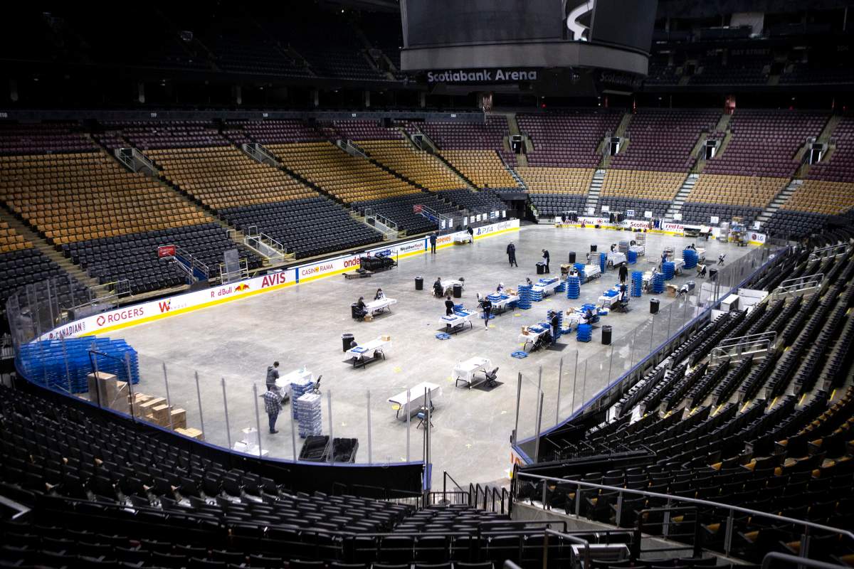 An MLSE employee puts together meals as staff work on the floor of Scotiabank Arena, in Toronto on Wednesday, April 22, 2020. The meals are being donated as part of an initiative with partners such as Second Harvest, and are being distributed to front-line workers and homeless shelters during the COVID-19 pandemic.