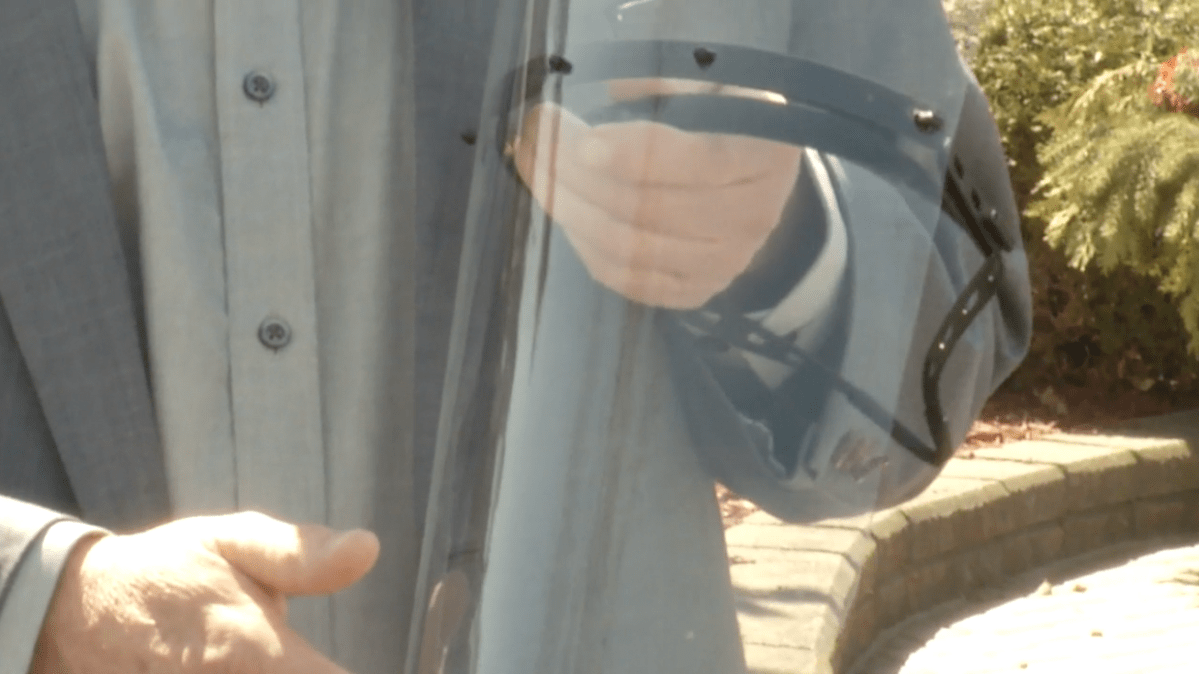 Terry Harris of Harco Enterprises Ltd. in Peterborough shows a face shield made at the company.