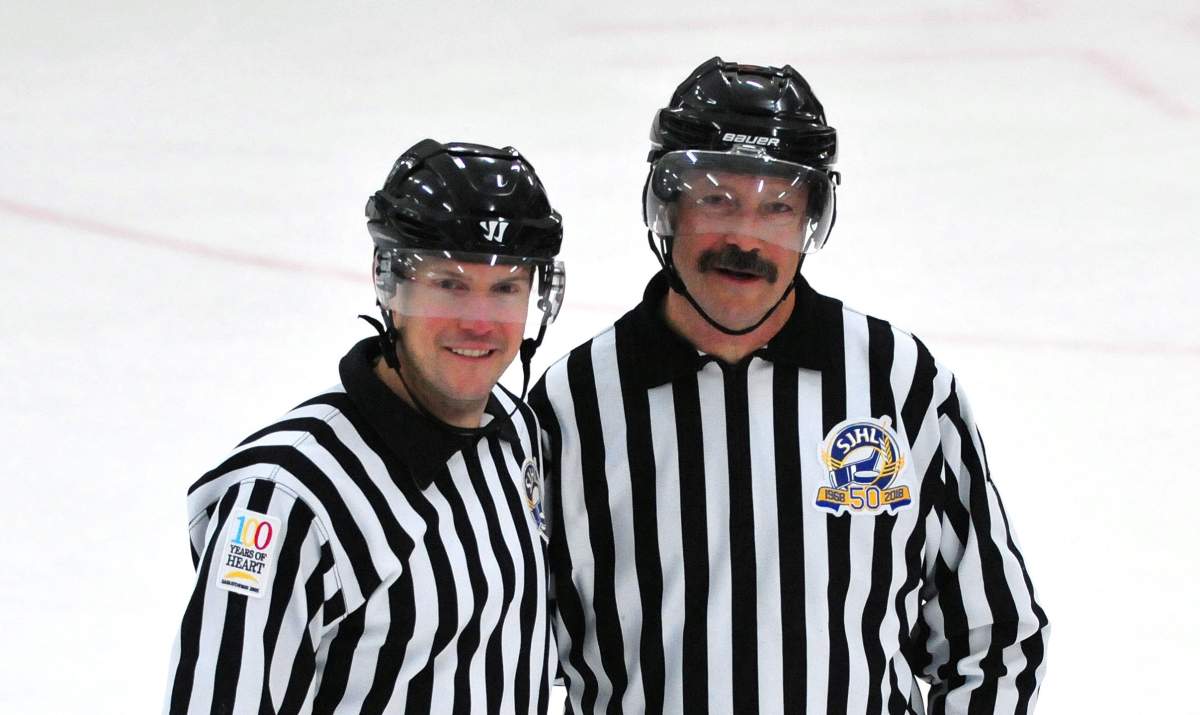 Bruce Skilliter (right) officiates the last game of his career with his son, Graham.
