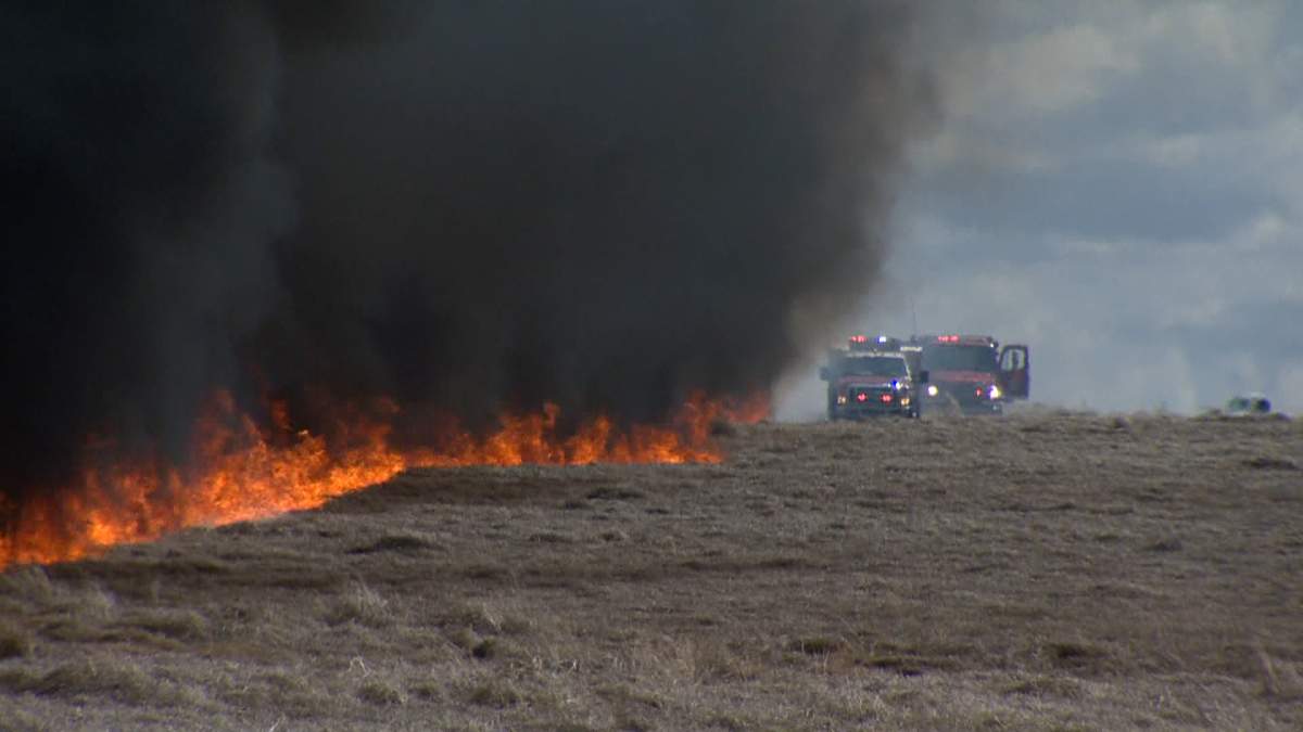 Crews from the Calgary Fire Department and Tsuut’ina Nation fight a wildfire in the city’s southwest on Friday, May 1, 2020.