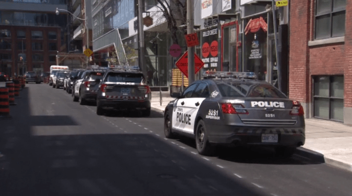 Police at the scene where a man was found with "significant injuries" in the area of Richmond and John streets on Saturday.