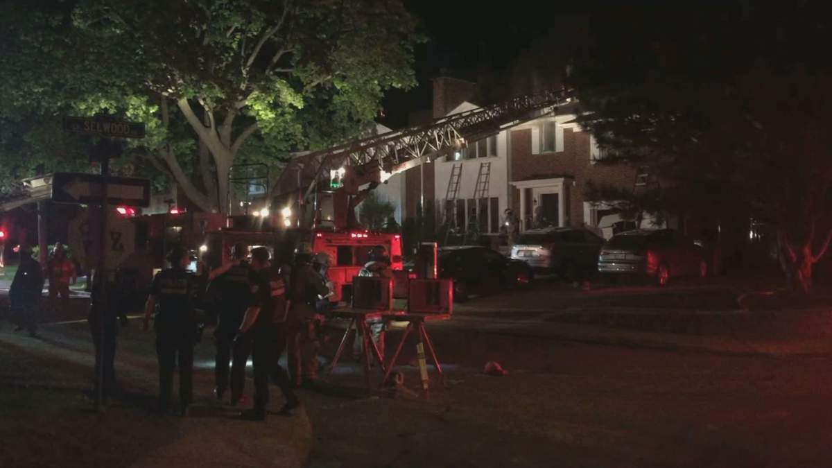 Montreal firefighters battle flames in a home on Lethbridge Avenue in the town of Mount Royal, Que., early on the morning of May 22, 2020.