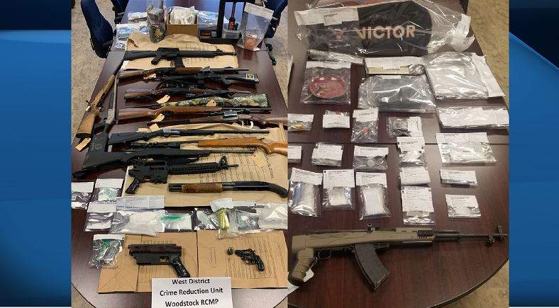 Police say 17 weapons and drugs were seized as a result of the two search warrants being executed. 