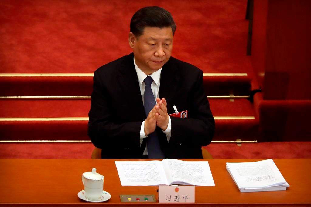 Chinese President Xi Jinping applauds during the opening session of China's National People's Congress (NPC) at the Great Hall of the People in Beijing, Friday, May 22, 2020.