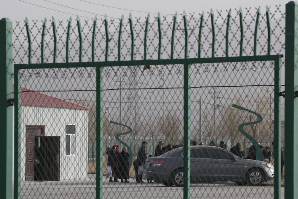 In this Monday, Dec. 3, 2018, file photo, people line up at the Artux City Vocational Skills Education Training Service Center at the Kunshan Industrial Park in Artux in western China’s Xinjiang region. The Associated Press has found that the Chinese government is carrying out a birth control program aimed at Uighurs, Kazakhs and other largely Muslim minorities in Xinjiang, even as some of the country’s Han majority is encouraged to have more children. The measures include detention in prisons and camps, such as this facility in Artux, as punishment for having too many children.