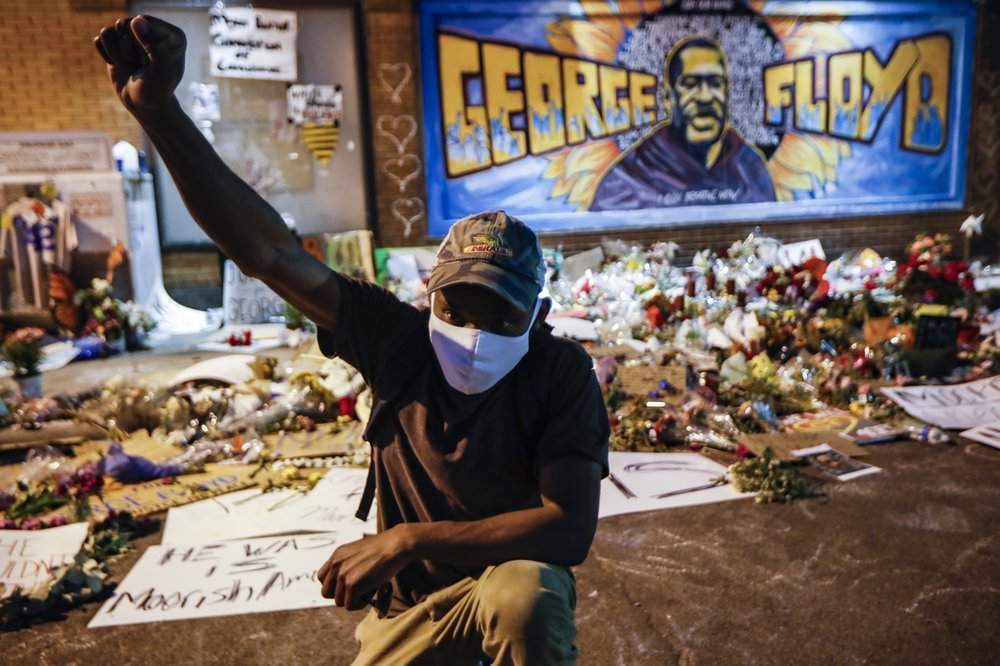 FILE - In this Monday, June 1, 2020 file photo, protesters gather at a memorial for George Floyd where he died outside Cup Foods on East 38th Street and Chicago Avenue in Minneapolis. Floyd died after being restrained by Minneapolis police officers on May 25. The deaths of Floyd and other black men at the hands of Minneapolis police have exacerbated the corrosive relationship between people of color and a criminal justice system they feel is stacked against them. 