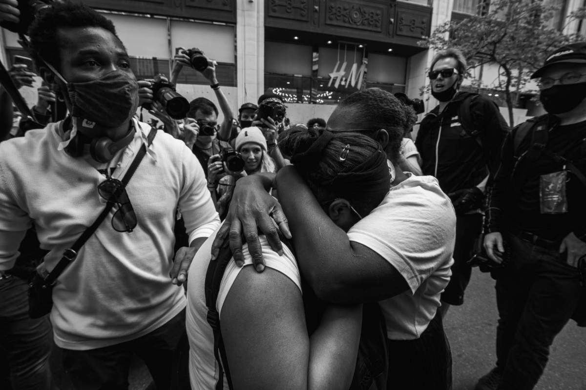 Marcelin hugging a protester during Sunday’s march.