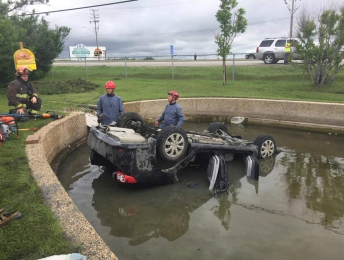 Car flips over into Winnipeg cemetery pond - image