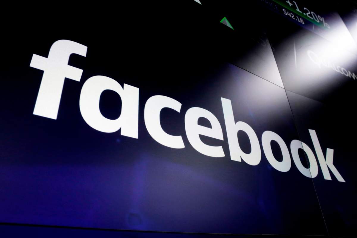 FILE - This March 29, 2018, file photo shows the Facebook logo on screens at the Nasdaq MarketSite in New York's Times Square.