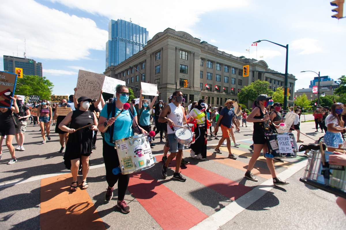 Demonstrators march down Wellington Street in downtown London, Ont., as part of a Black Lives Matter rally to protest racism, systemic discrimination, and police brutality, June 6, 2020.